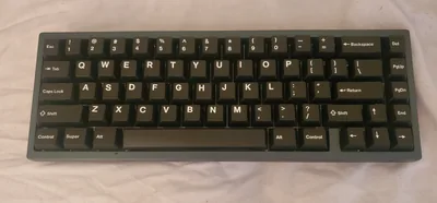 Mode Envoy Mirage 65% keyboard with blue case, gold weight, and keycaps